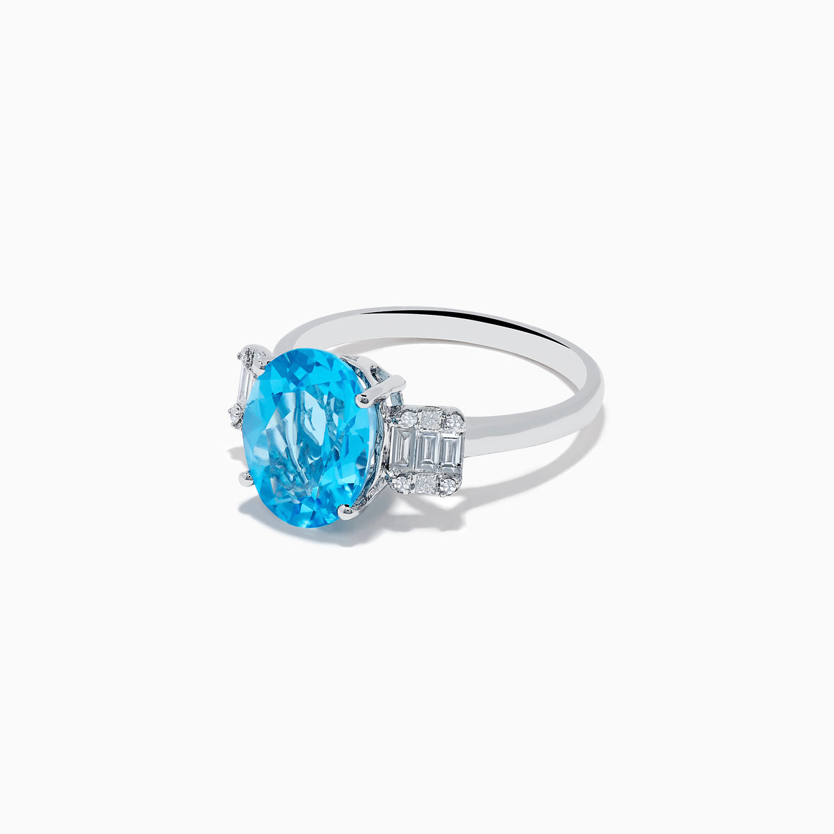 The Ocean Bleu 14K White Gold Blue Topaz and Diamond ring showcases a large oval blue topaz center stone, accented by two rectangular diamonds on each side, set against a white background.
