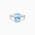 The 14K White Gold Aquamarine and Diamond Double Hidden Halo Ring features an oval-cut aquamarine center with small round diamonds along the band, shown on a white background.