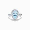 The Aquarius 14K White Gold Aquamarine and Diamond Cocktail Ring showcases a pear-shaped aquamarine with a double halo of round diamonds on a white gold band, beautifully displayed against a white background.