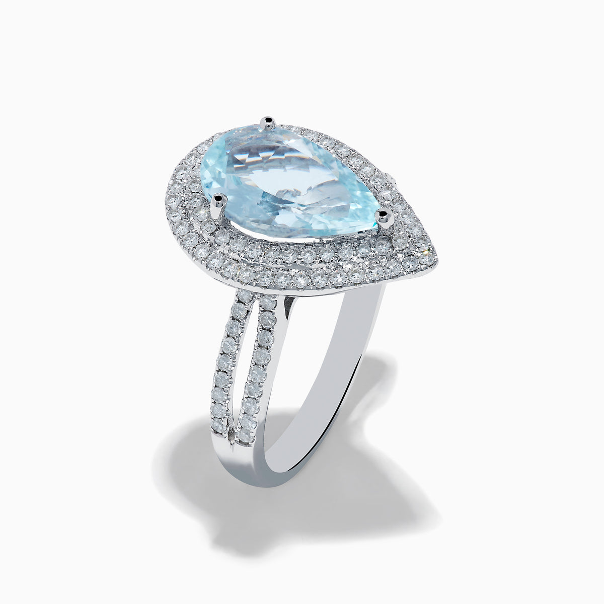 The Aquarius 14K White Gold Aquamarine and Diamond Cocktail Ring showcases a pear-shaped aquamarine with a double halo of round diamonds on a white gold band, beautifully displayed against a white background.