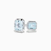 The 14K White Gold Double Aquamarine Ring features two light blue stones—one encircled by diamonds in a halo setting and the other set in a minimal geometric design.