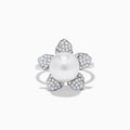 The 14K White Gold Fresh Water Pearl and Diamond Flower Ring features a large pearl at the center, surrounded by five diamond-accented petals on a sleek white gold band.
