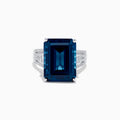 The Ocean Bleu 14K White Gold London Blue Topaz and Diamond Cocktail Ring showcases a large emerald-cut blue topaz set with four prongs, accented by sparkling diamonds along the band.
