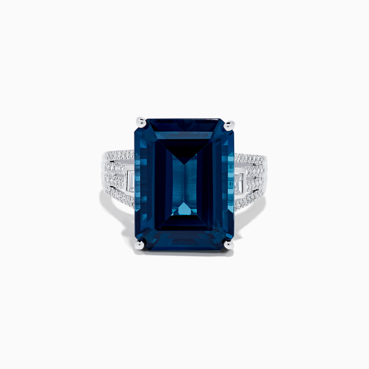 The Ocean Bleu 14K White Gold London Blue Topaz and Diamond Cocktail Ring showcases a large emerald-cut blue topaz set with four prongs, accented by sparkling diamonds along the band.