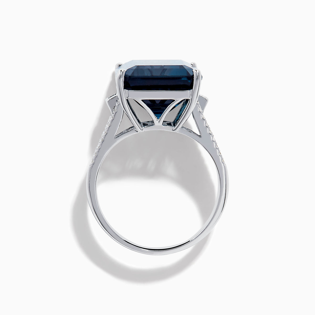 The Ocean Bleu 14K White Gold London Blue Topaz and Diamond Cocktail Ring showcases a large emerald-cut blue topaz set with four prongs, accented by sparkling diamonds along the band.