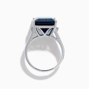 The Ocean Bleu 14K White Gold London Blue Topaz and Diamond Cocktail Ring showcases a large emerald-cut blue topaz set with four prongs, accented by sparkling diamonds along the band.
