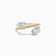 The Aquarius 14K Yellow Gold Aquamarine and Diamond Ring features two pear-shaped light blue aquamarines at each end and a spiral band partially encrusted with diamonds that wraps elegantly around the finger.