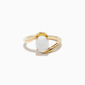 The Aurora 14K Yellow Gold Opal and Diamond Ring showcases an oval white opal center stone accented by small round diamonds on one side of the band, shown against a white background.
