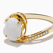 The Aurora 14K Yellow Gold Opal and Diamond Ring showcases an oval white opal center stone accented by small round diamonds on one side of the band, shown against a white background.