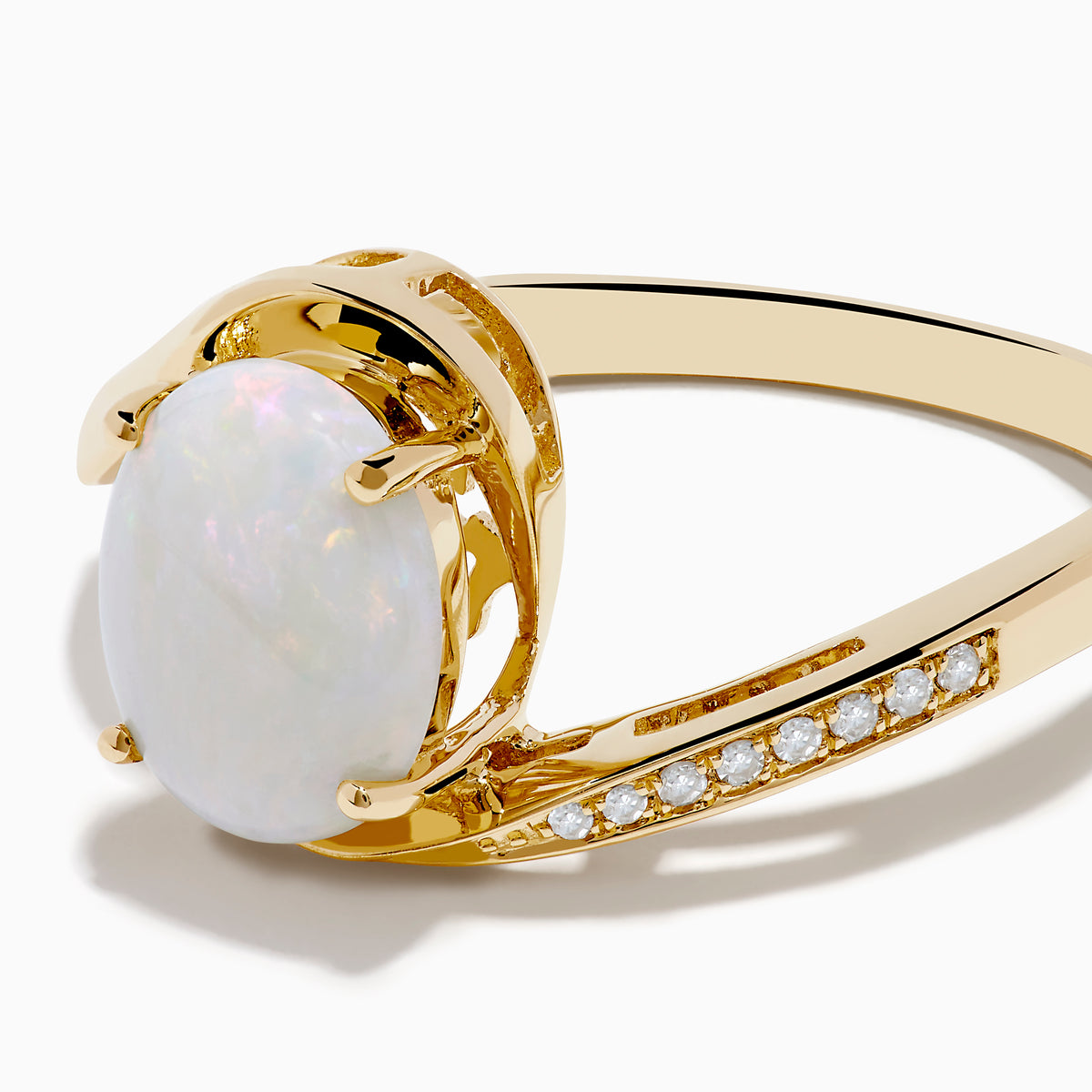 The Aurora 14K Yellow Gold Opal and Diamond Ring showcases an oval white opal center stone accented by small round diamonds on one side of the band, shown against a white background.
