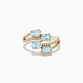 The Aquarius 14K Yellow Gold Aquamarine and Diamond Bypass Ring features two overlapping bands with sparkling diamonds and four diagonally set oval aquamarines.