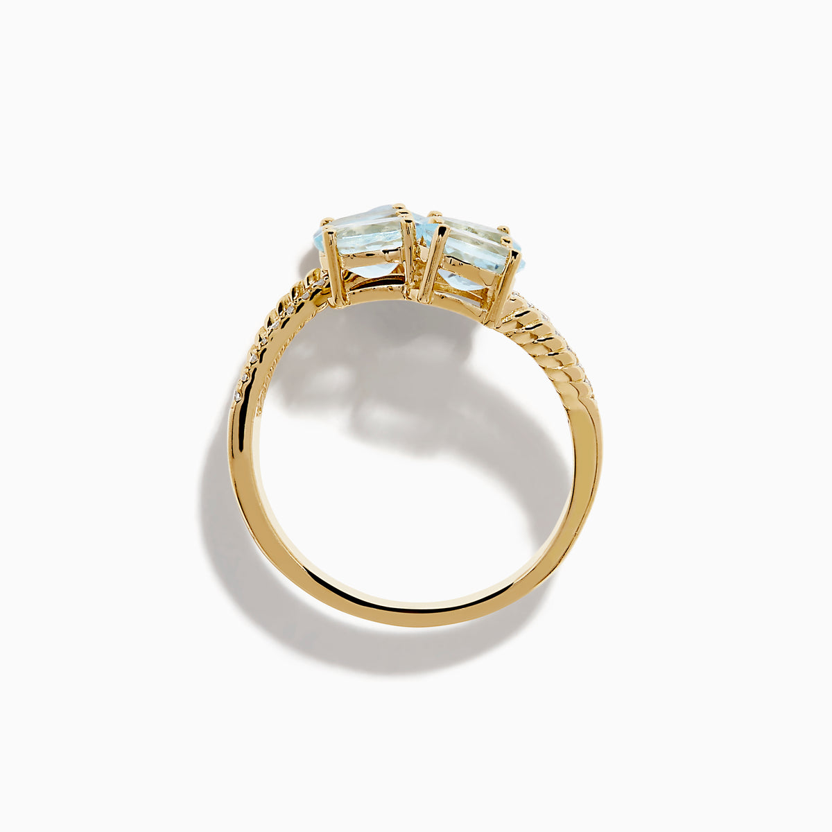 The Aquarius 14K Yellow Gold Aquamarine and Diamond Bypass Ring features two overlapping bands with sparkling diamonds and four diagonally set oval aquamarines.