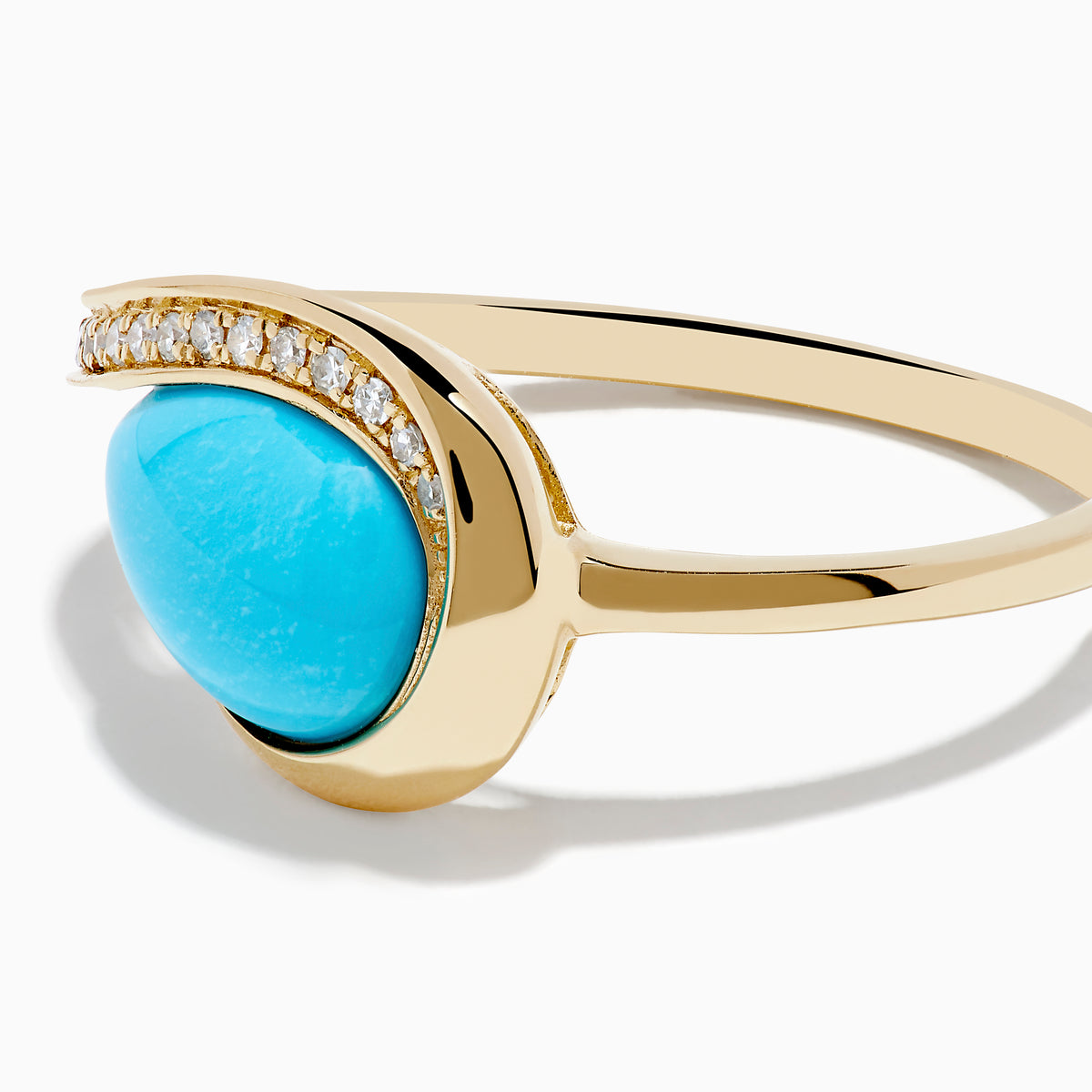 The Terra 14K Yellow Gold Turquoise and Diamond Ring showcases an asymmetrical turquoise stone and a curved band with small white diamonds, set against a white background.
