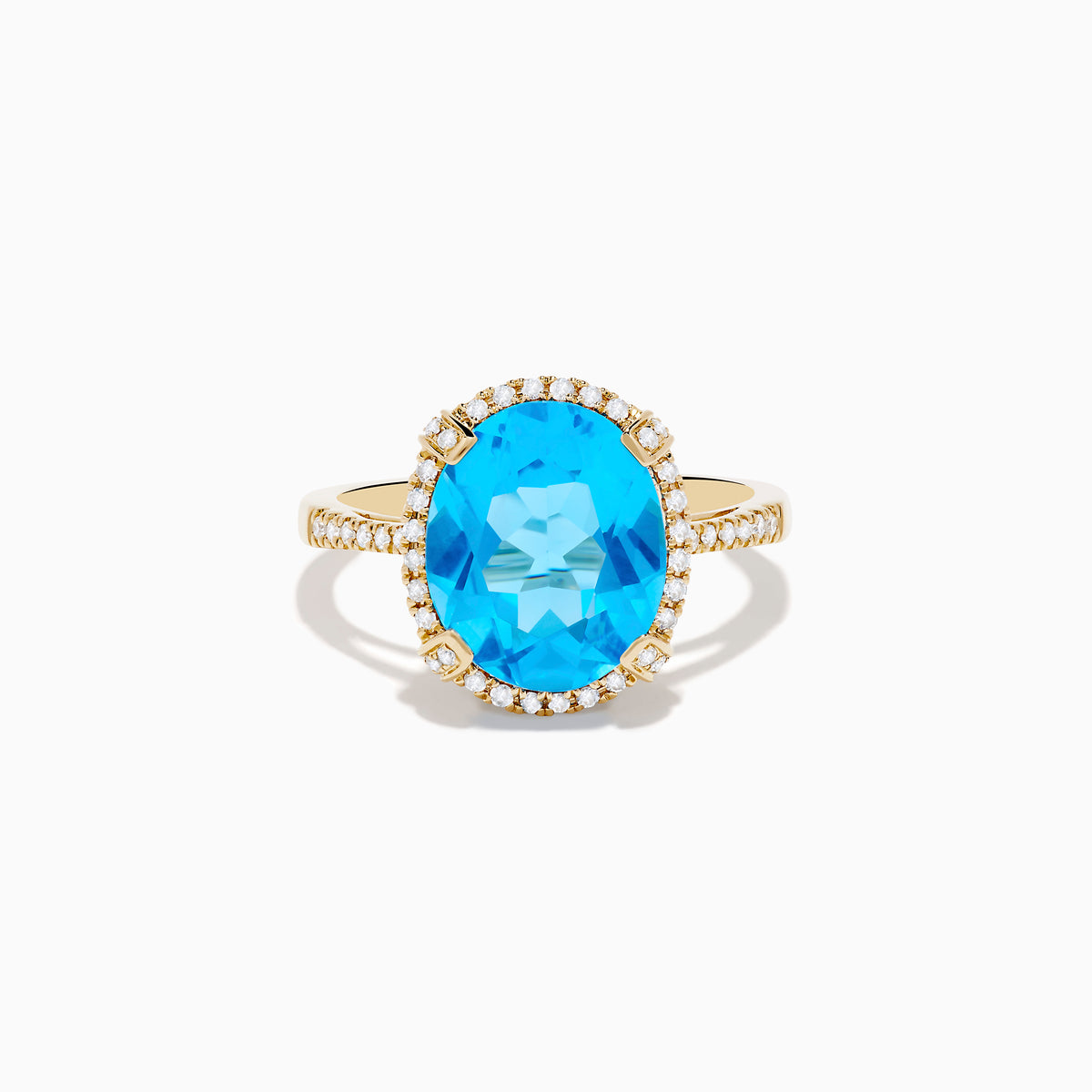 The Ocean Bleu 14K Yellow Gold Blue Topaz Ring showcases a large oval center blue topaz, embraced by a diamond halo and additional diamonds adorning the band.