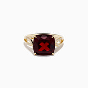 The Bordeaux 14K Yellow Gold Garnet and Diamond Ring showcases a large cushion-cut deep red garnet centered on an intricately designed band with sparkling diamond accents.