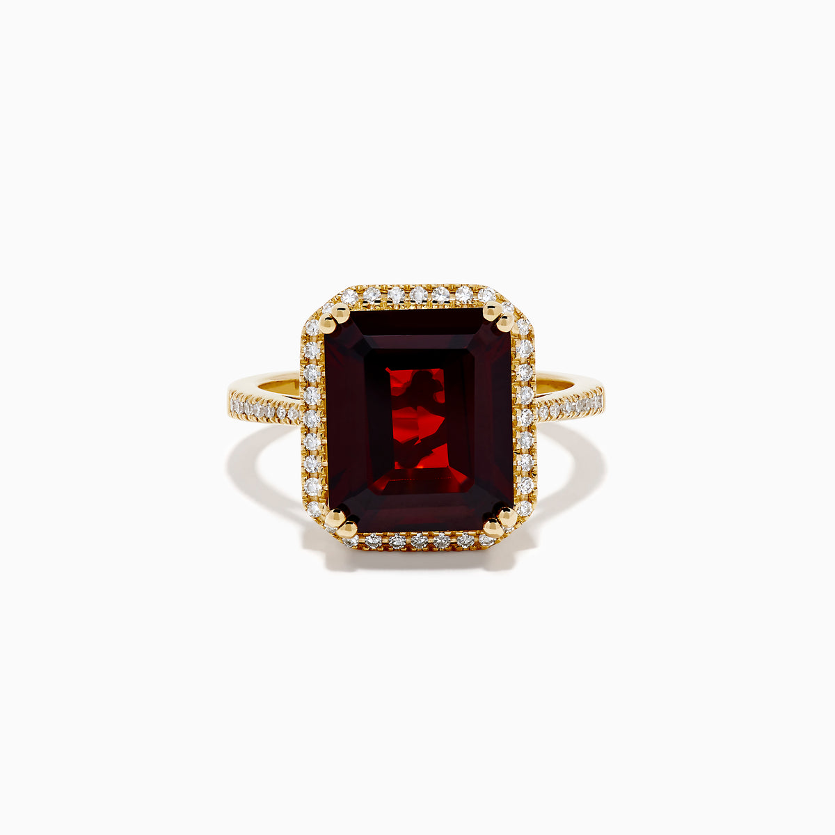 The 14K Yellow Gold Garnet and Diamond Halo Cocktail Ring showcases a large rectangular deep red garnet, surrounded by a diamond halo and diamonds on the band, set against a white background.