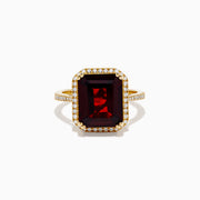The 14K Yellow Gold Garnet and Diamond Halo Cocktail Ring showcases a large rectangular deep red garnet, surrounded by a diamond halo and diamonds on the band, set against a white background.