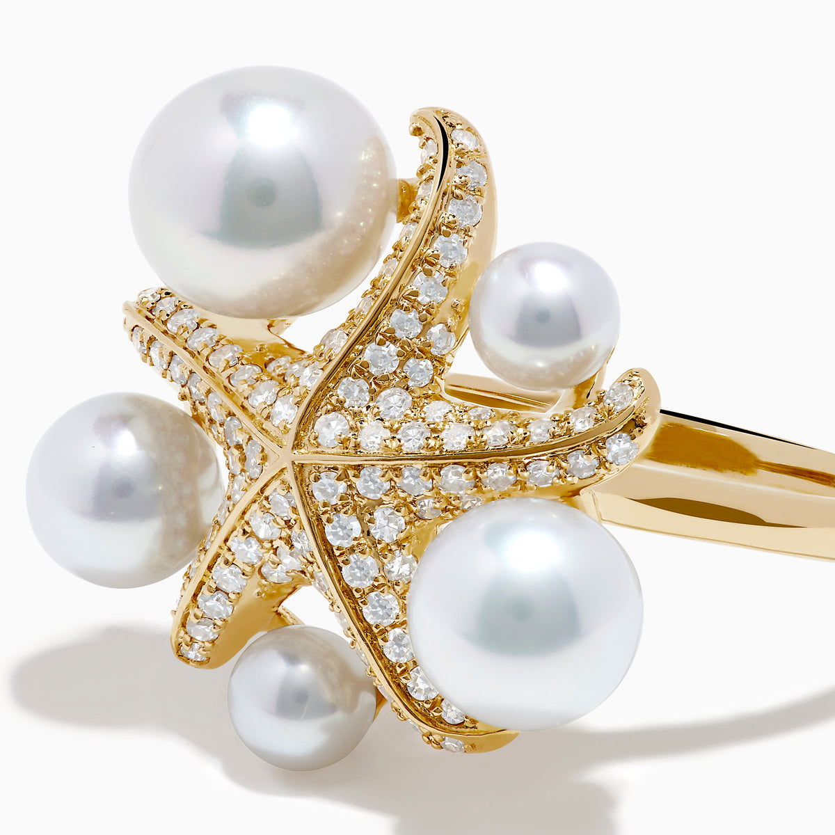 The 14K Yellow Gold Pearl and Diamond Starfish Ring showcases five large white pearls of varying sizes and a sparkling diamond starfish design.