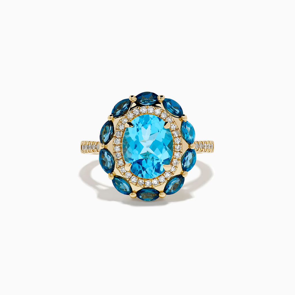 The Ocean Bleu 14K Yellow Gold Blue Topaz and Diamond Ring showcases a large oval blue topaz center, haloed by clear diamonds and marquise deep blue stones, all set on a textured yellow gold band.
