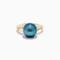 The 14K Yellow Gold Diamond Black Tahitian Pearl Ring features a striking round black Tahitian pearl at the center, accented by diamonds set along each side of the elegant split band.