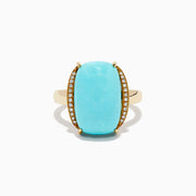 The 14K Yellow Gold Cabochon Turquoise and Diamond Ring showcases a large rectangular turquoise cabochon accented by two rows of sparkling white diamonds on each side, all set in polished yellow gold.