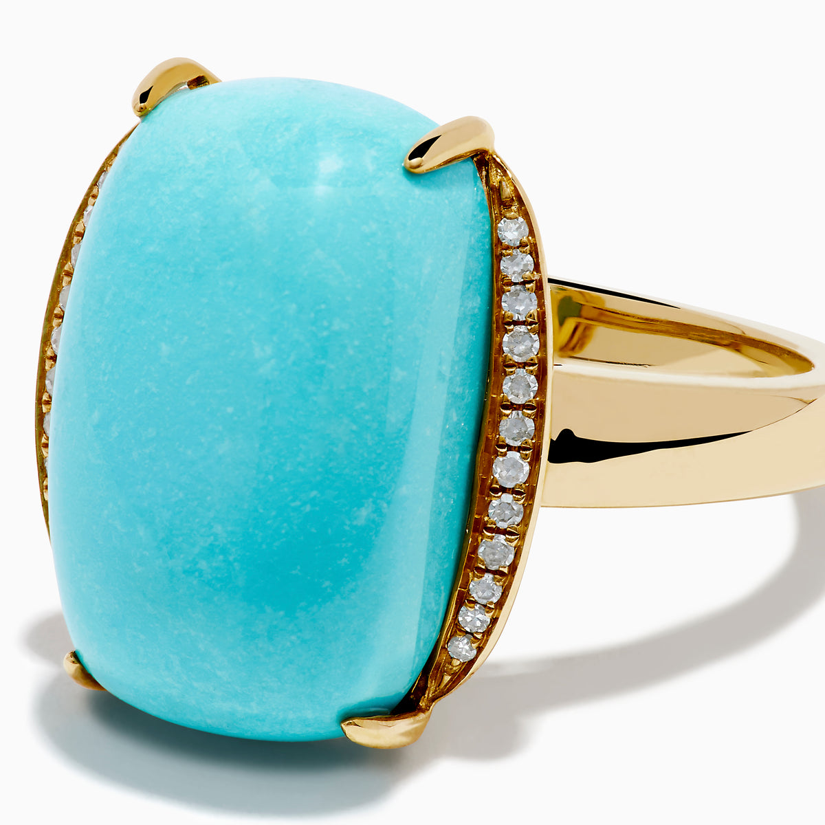 The 14K Yellow Gold Cabochon Turquoise and Diamond Ring showcases a large rectangular turquoise cabochon accented by two rows of sparkling white diamonds on each side, all set in polished yellow gold.