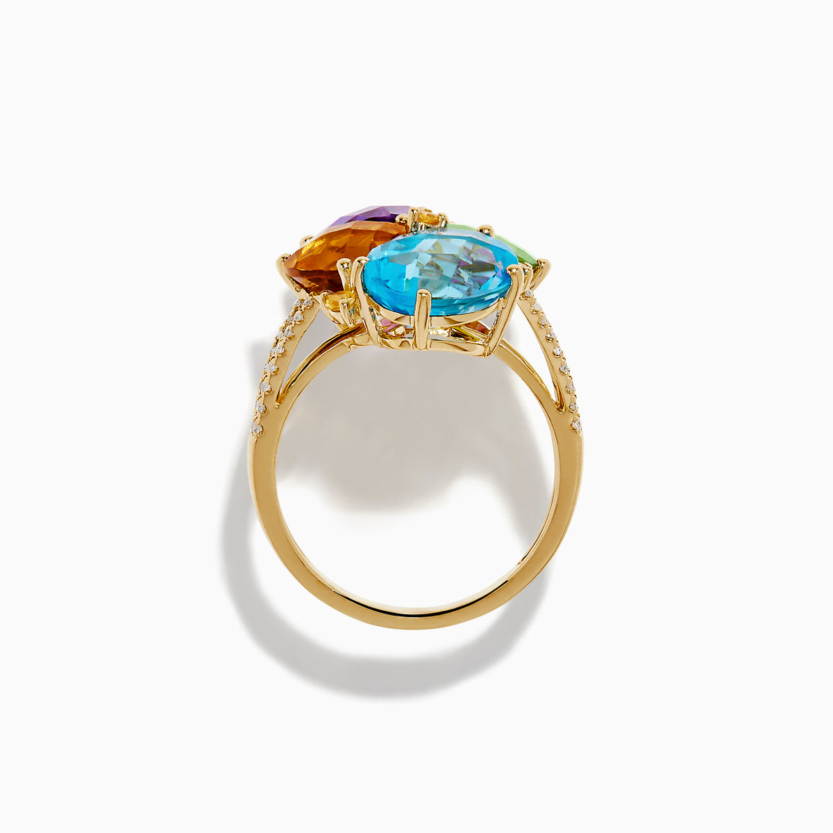 The 14K Yellow Gold Multi Color Gemstone and Diamond Cluster Ring features four large, pear-shaped blue, green, orange, and purple stones in a floral design with a diamond cluster accent on the band, shown on a white background.