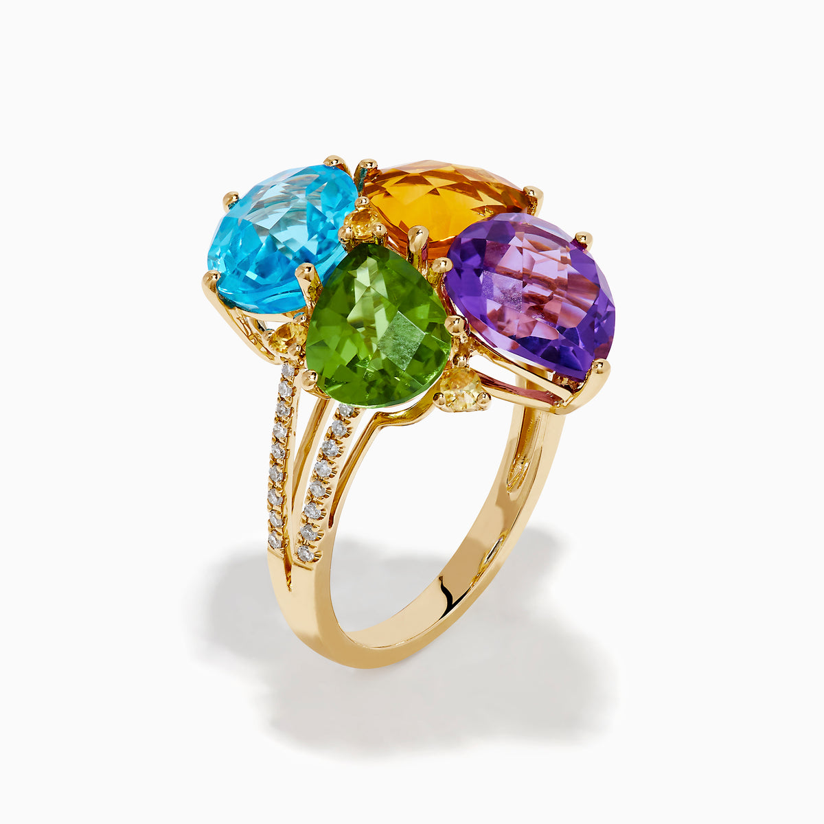 The 14K Yellow Gold Multi Color Gemstone and Diamond Cluster Ring features four large, pear-shaped blue, green, orange, and purple stones in a floral design with a diamond cluster accent on the band, shown on a white background.