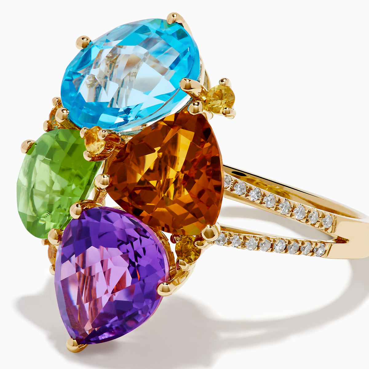 The 14K Yellow Gold Multi Color Gemstone and Diamond Cluster Ring features four large, pear-shaped blue, green, orange, and purple stones in a floral design with a diamond cluster accent on the band, shown on a white background.