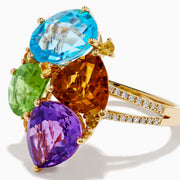 The 14K Yellow Gold Multi Color Gemstone and Diamond Cluster Ring features four large, pear-shaped blue, green, orange, and purple stones in a floral design with a diamond cluster accent on the band, shown on a white background.