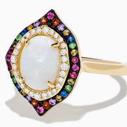 The 14K Yellow Gold Opal, Multi Gemstone and Diamond Ring showcases an oval opal center with dual halos of white diamonds and multicolored gems in a marquise-shaped design on a white background.