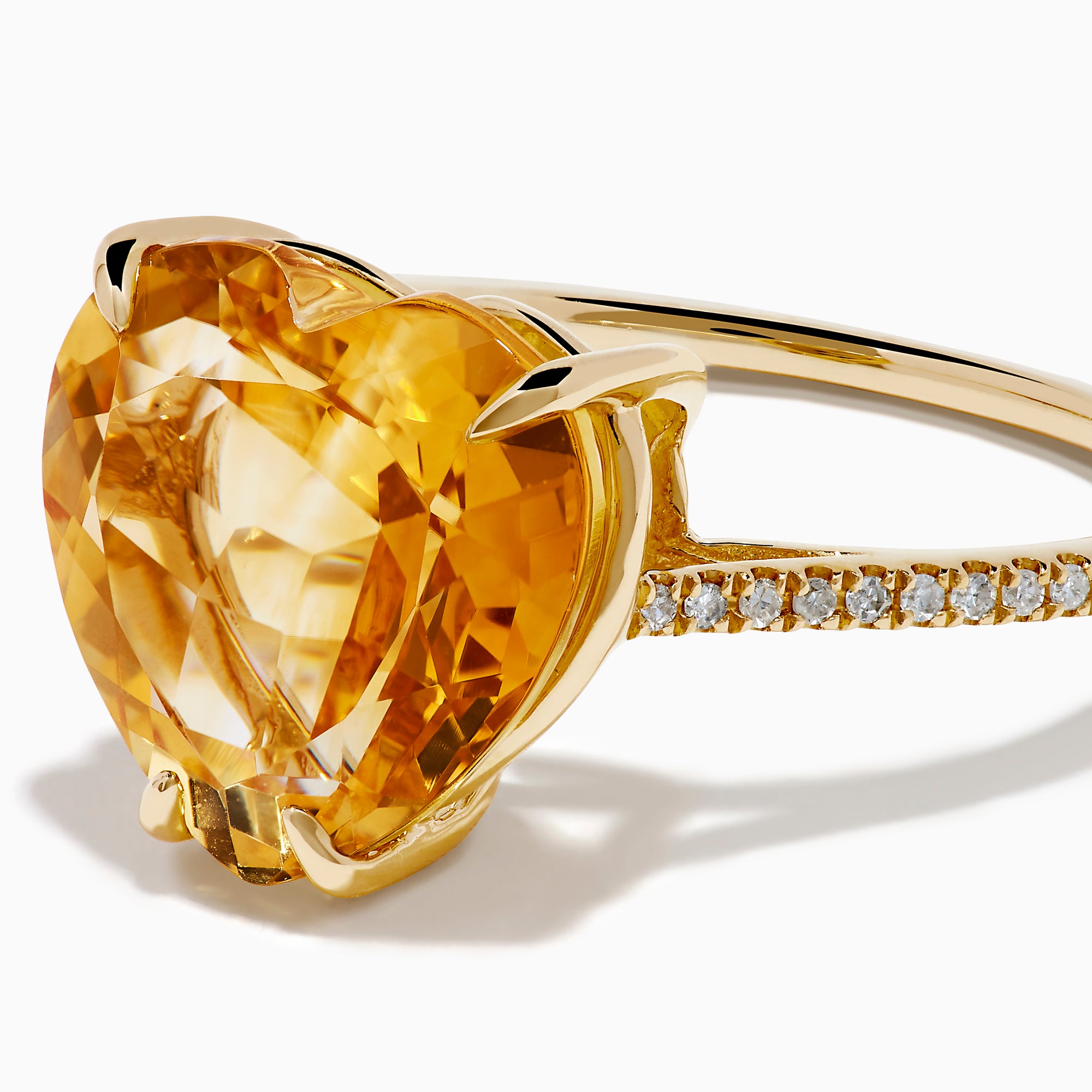 The Sunset 14K Yellow Gold Citrine and Diamond Heart Ring features a large heart-shaped citrine gemstone at the center, accented by small diamonds on the band, and is pictured against a white background.