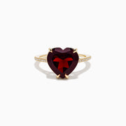 The Bordeaux 14K Yellow Gold Garnet and Diamond Heart Ring features a large heart-shaped deep red garnet at the center with small diamonds on the band, shown against a white background.