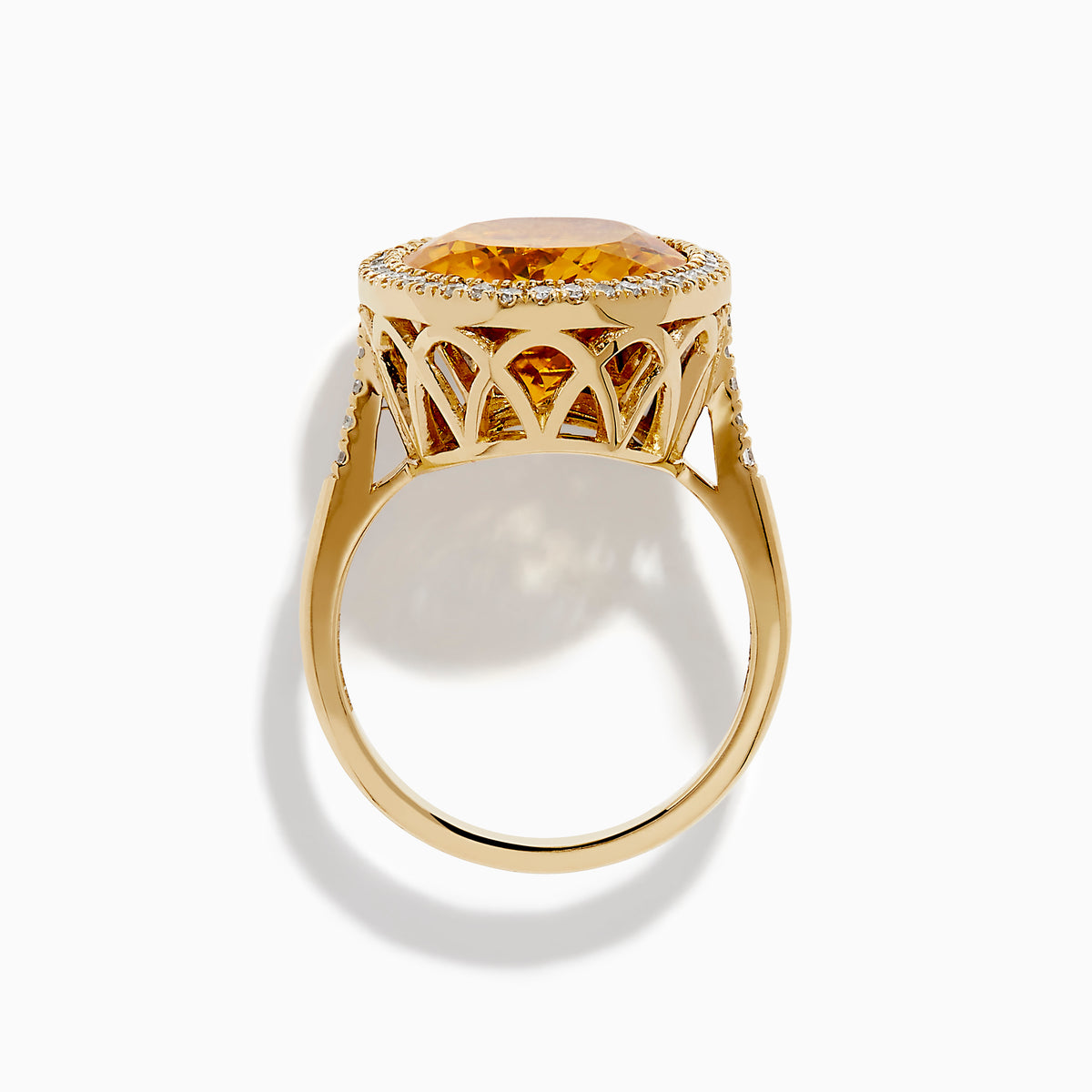 The Sunset 14K Yellow Gold Citrine and Diamond Halo Ring showcases a large oval citrine center stone encircled by a sparkling diamond halo, elegantly displayed on a plain white background.