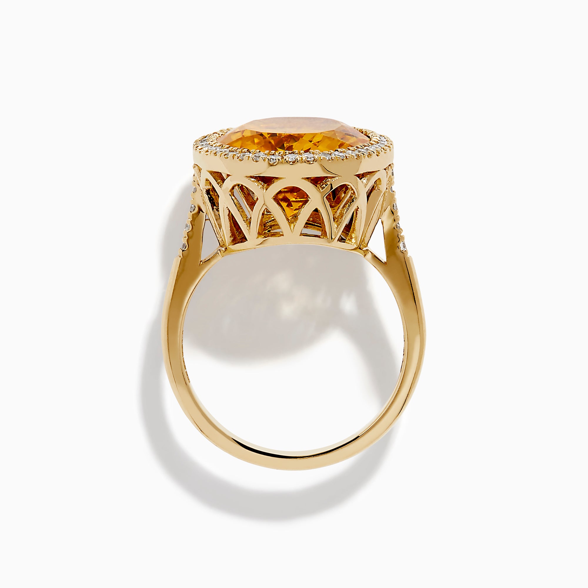 The Sunset 14K Yellow Gold Citrine and Diamond Halo Ring showcases a large oval citrine center stone encircled by a sparkling diamond halo, elegantly displayed on a plain white background.
