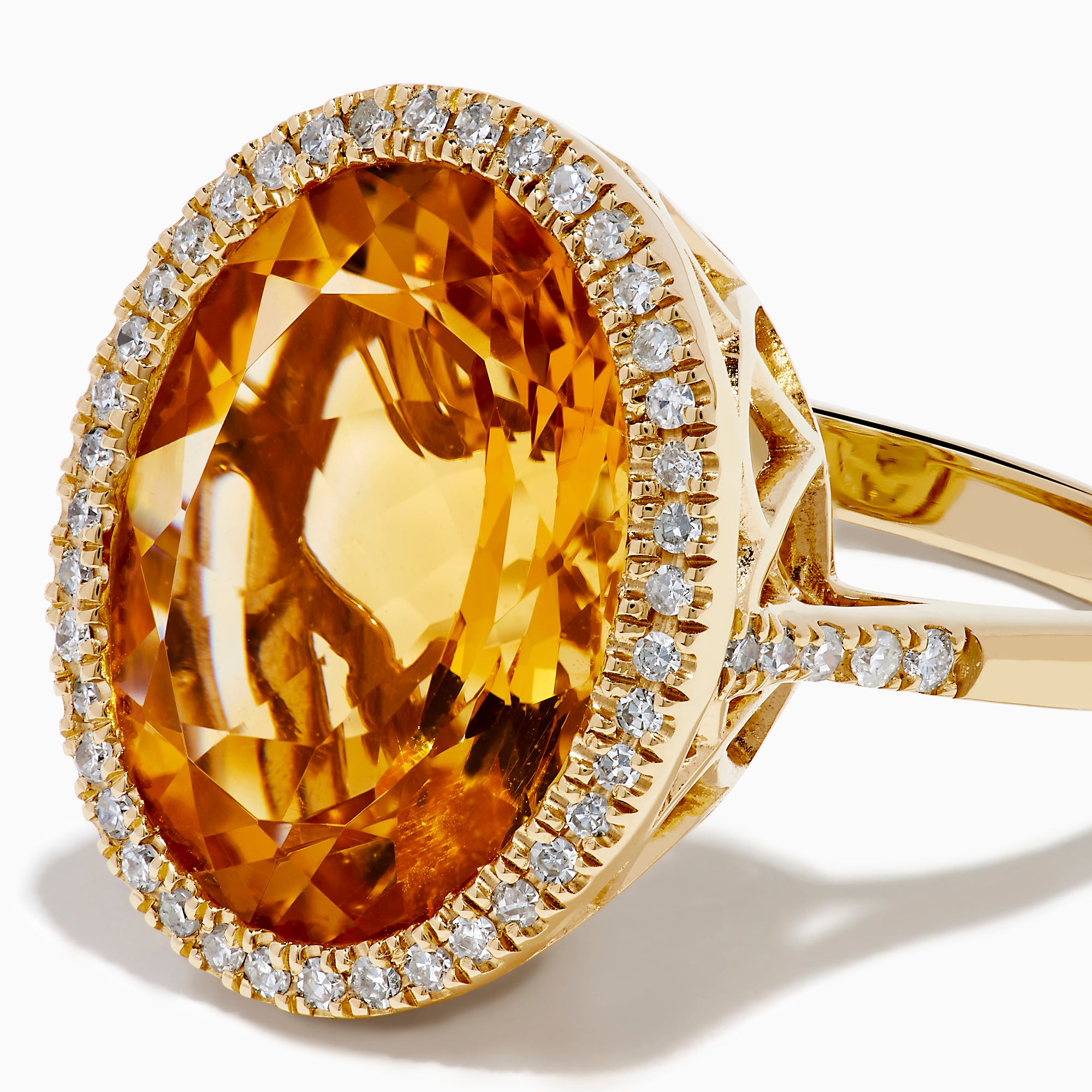 The Sunset 14K Yellow Gold Citrine and Diamond Halo Ring showcases a large oval citrine center stone encircled by a sparkling diamond halo, elegantly displayed on a plain white background.