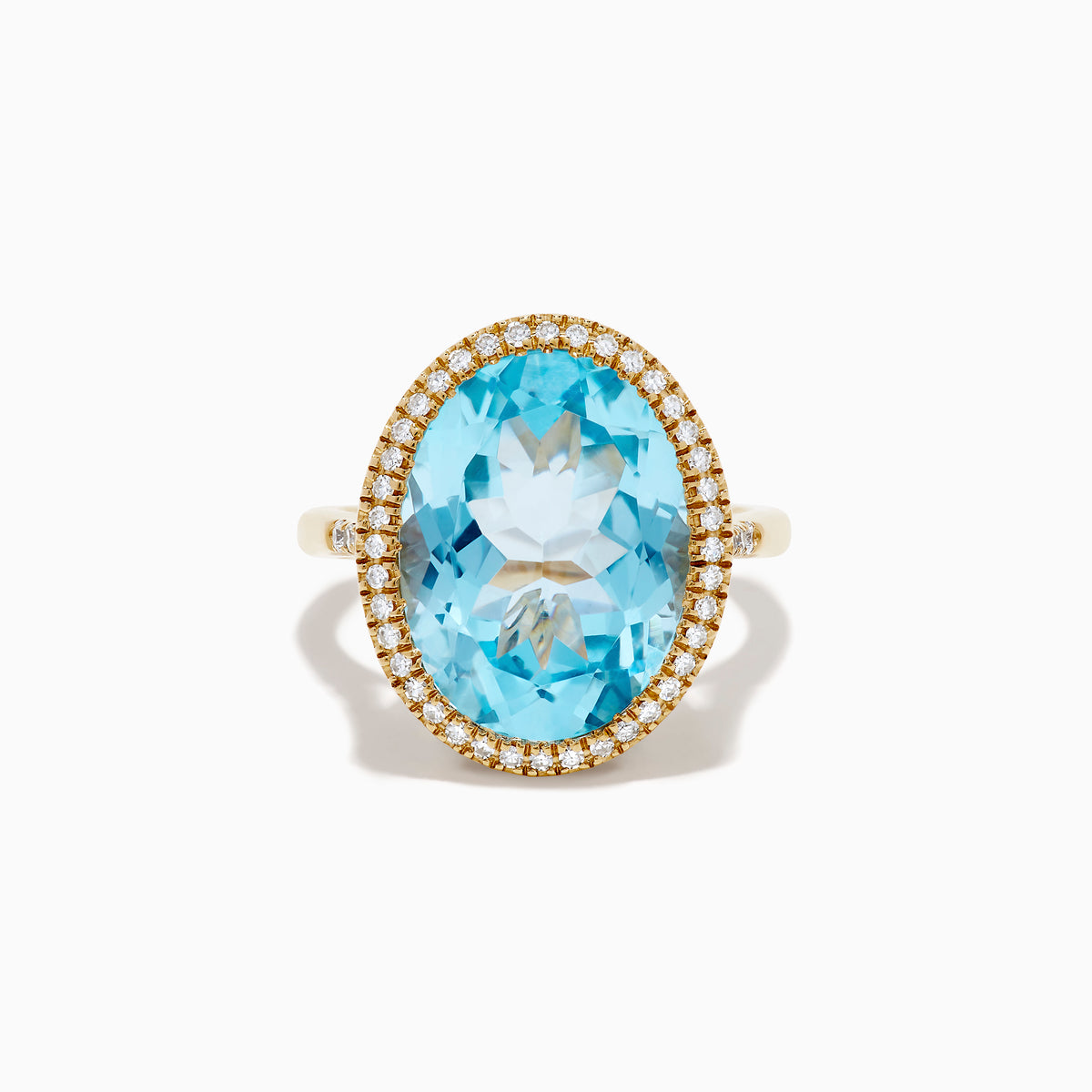 The 14K Yellow Gold Blue Topaz and Diamond Halo Cocktail Ring showcases a large oval blue topaz gemstone surrounded by sparkling diamonds, presented against a simple white background.