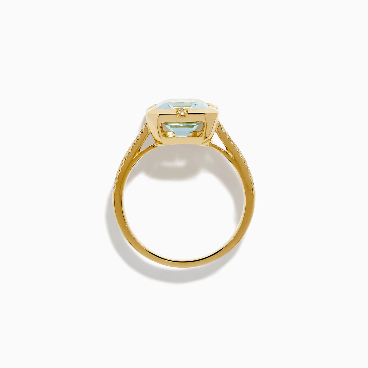 The 14K Yellow Gold Aquamarine and Diamond Bezel Solitaire Ring showcases an emerald-cut light blue aquamarine center stone with diamond accents on the band, displayed against a white background.