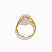The 14K Yellow Gold Aquamarine and Diamond Bezel Solitaire Ring showcases an emerald-cut light blue aquamarine center stone with diamond accents on the band, displayed against a white background.