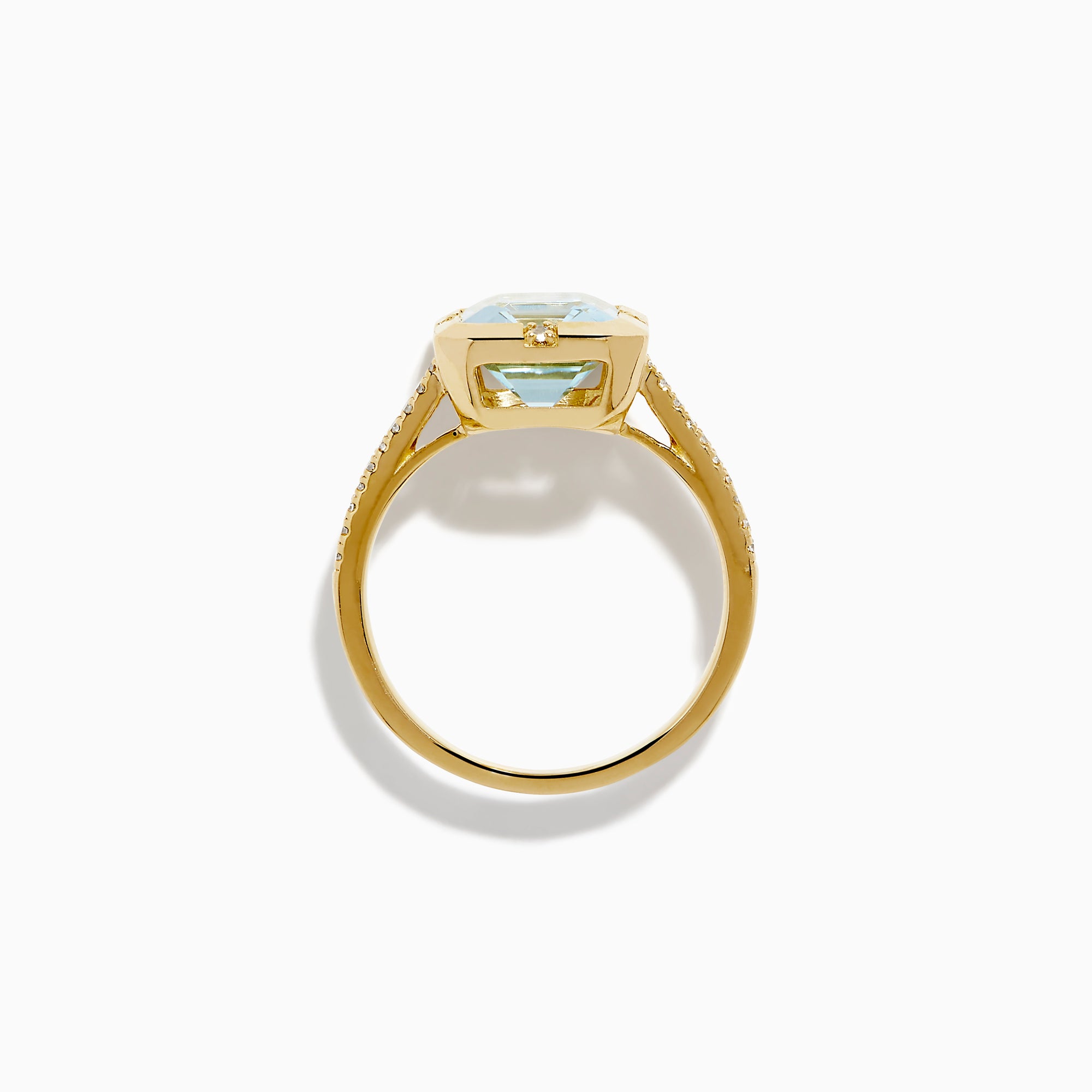 The 14K Yellow Gold Aquamarine and Diamond Bezel Solitaire Ring showcases an emerald-cut light blue aquamarine center stone with diamond accents on the band, displayed against a white background.