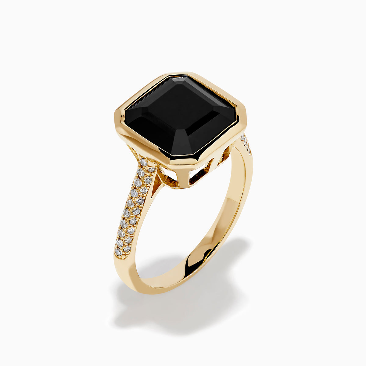 The 14K Yellow Gold Bezel Set Black Onyx and Diamond Ring features a bold square-cut black onyx center stone and sparkling diamonds set along the band.