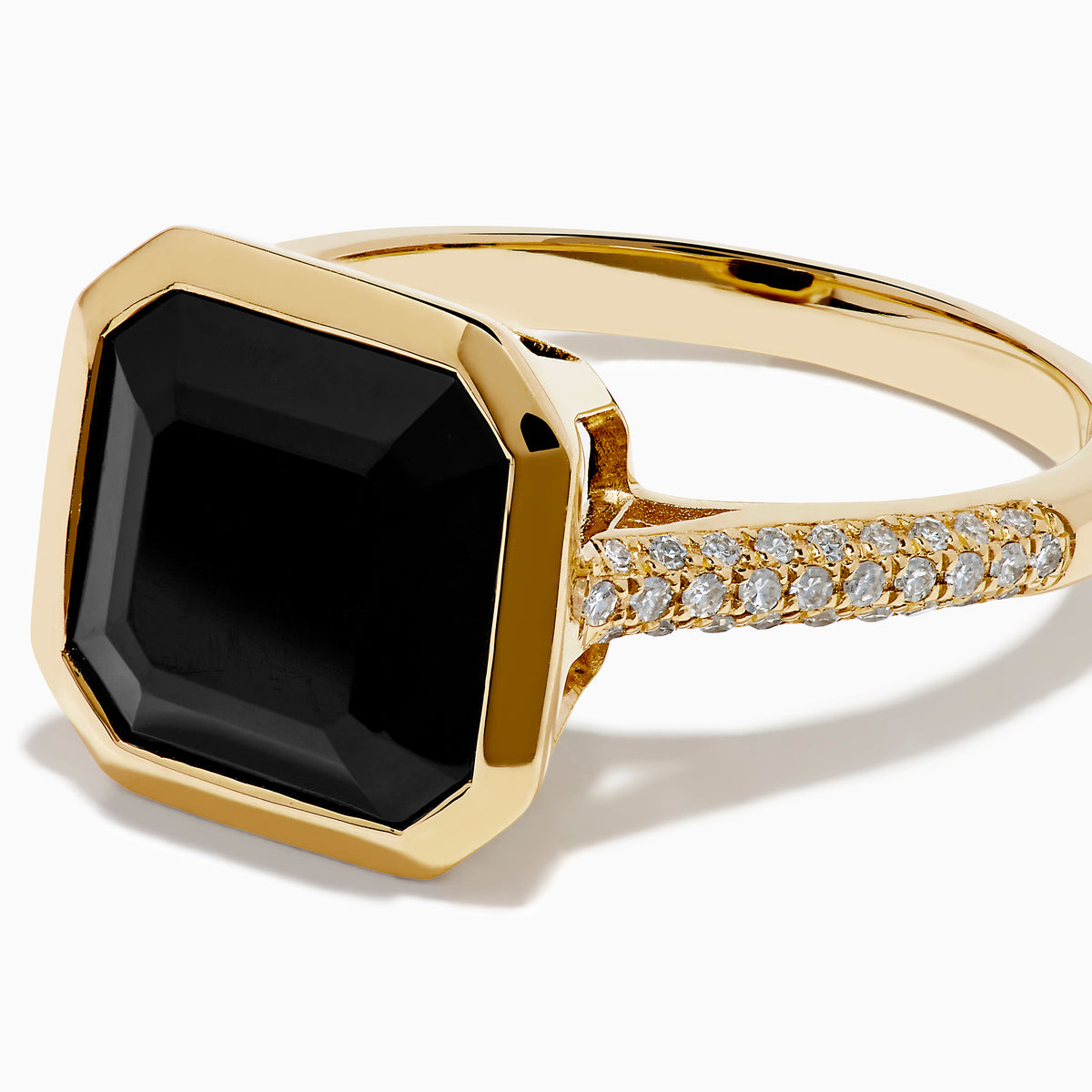 The 14K Yellow Gold Bezel Set Black Onyx and Diamond Ring features a bold square-cut black onyx center stone and sparkling diamonds set along the band.