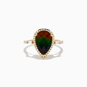 The 14K Yellow Gold Ammolite and Diamond Ring features a large pear-shaped ammolite center, a diamond halo, and additional baguette diamonds set along the band.