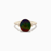 The 14K Yellow Gold Ammolite and Diamond Ring features a large oval faceted ammolite with dark green and red hues, flanked by two small rectangular stones and a band adorned with small sparkling diamonds.