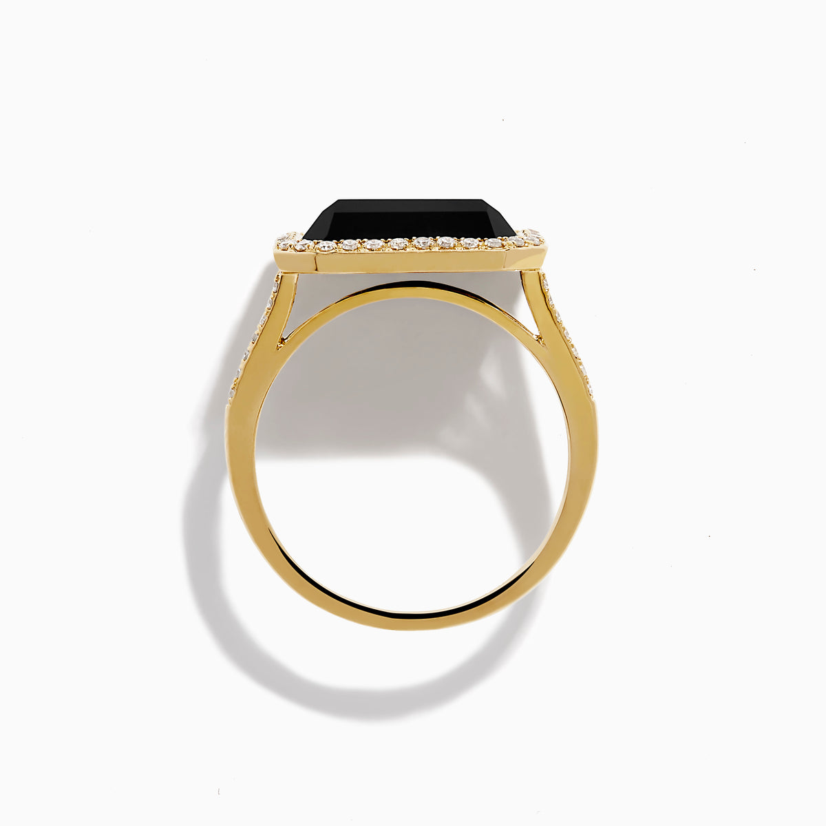 The 14K Yellow Gold Onyx and Diamond Ring showcases a large rectangular onyx bordered by sparkling white diamonds, with extra diamond accents along the elegant split band.