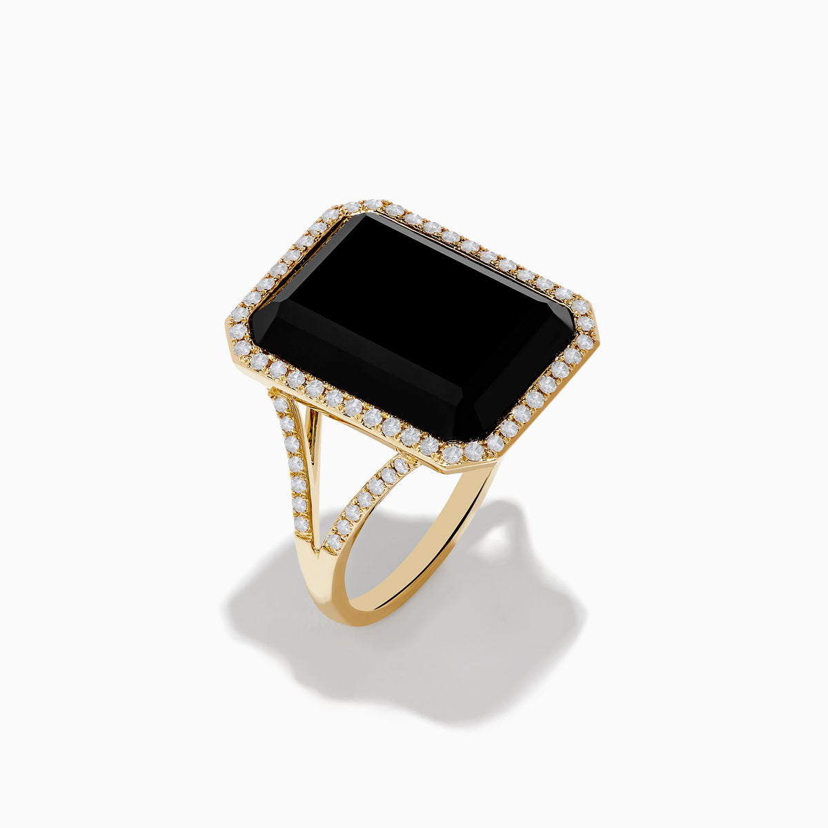 The 14K Yellow Gold Onyx and Diamond Ring showcases a large rectangular onyx bordered by sparkling white diamonds, with extra diamond accents along the elegant split band.