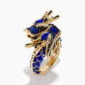 The Safari 14K Yellow Gold Diamond, Lapis and Sapphire Dragon Ring, shaped as a dragon’s head and body, features blue enamel scales and sparkling gemstones, evoking the fierce beauty of a sapphire dragon ring on a white background.