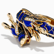 The Safari 14K Yellow Gold Diamond, Lapis and Sapphire Dragon Ring, shaped as a dragon’s head and body, features blue enamel scales and sparkling gemstones, evoking the fierce beauty of a sapphire dragon ring on a white background.