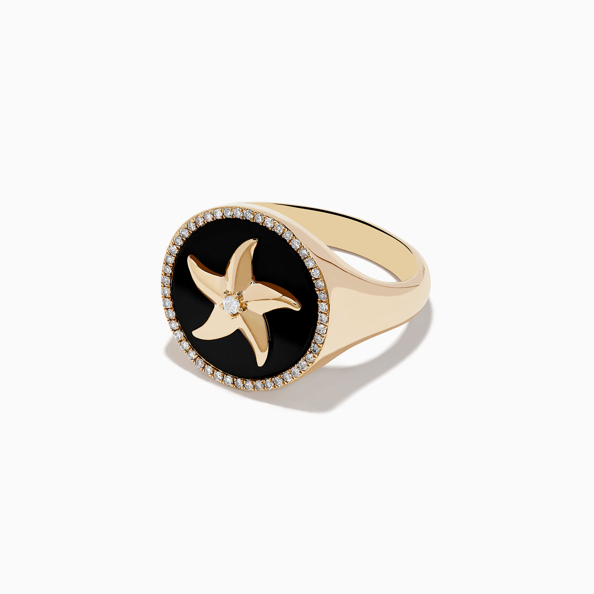 The Seaside 14K Yellow Gold Black Agate and Diamond Starfish Ring features a round black agate face, a gold starfish with a central diamond, and a border of small diamonds on the edge.