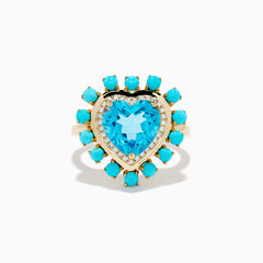 The 14K Yellow Gold Blue Topaz, Turquoise and Diamond Heart Cocktail Ring features a striking heart-shaped blue topaz center, surrounded by a halo of diamonds and an outer border of vibrant round turquoise stones.
